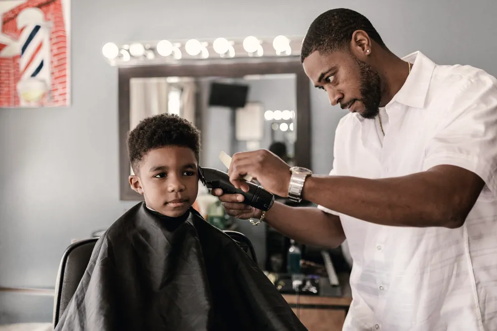 Barber cutting a young boy's hair