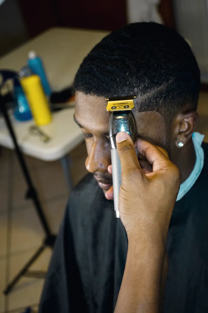 Barber lining up a client's waves with a trimmer